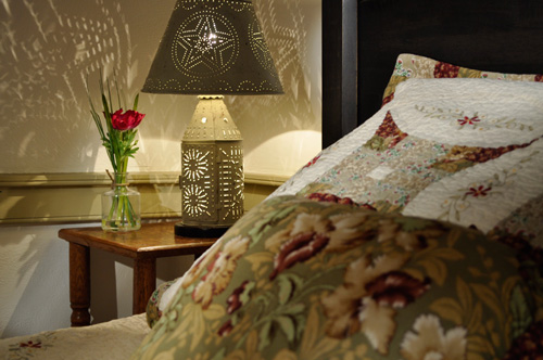 Punched tin lamp casts beautiful shadows in bedroom at the Jean Bonnet Tavern, Bedford, PA