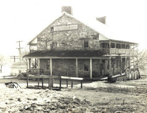 Early photo of Jean Bonnet Tavern with old car in fore, Bedford PA